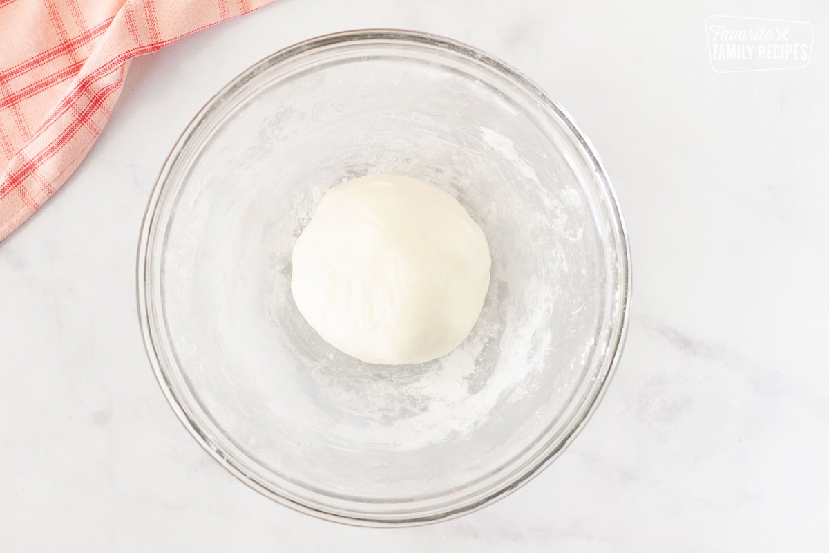 Ball of white fondant in a bowl for inner layer of Chocolate Covered Cherries.