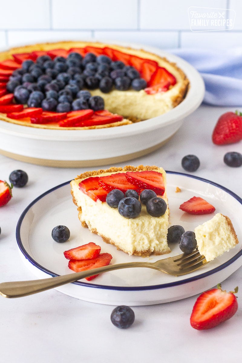 Fork with a cut of baked cheesecake and toppings for How to Make a Cheesecake.