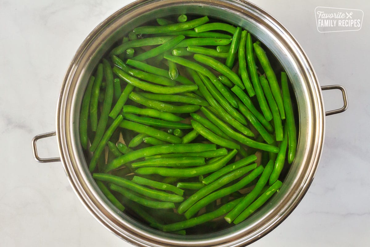 Fresh green beans in a pot of hot water for Green Bean Casserole.