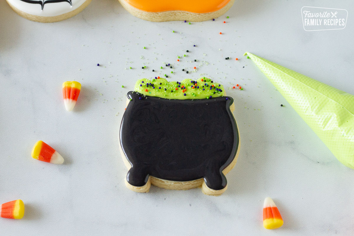 Green and colored sprinkles on the Cauldron Halloween Cookie.