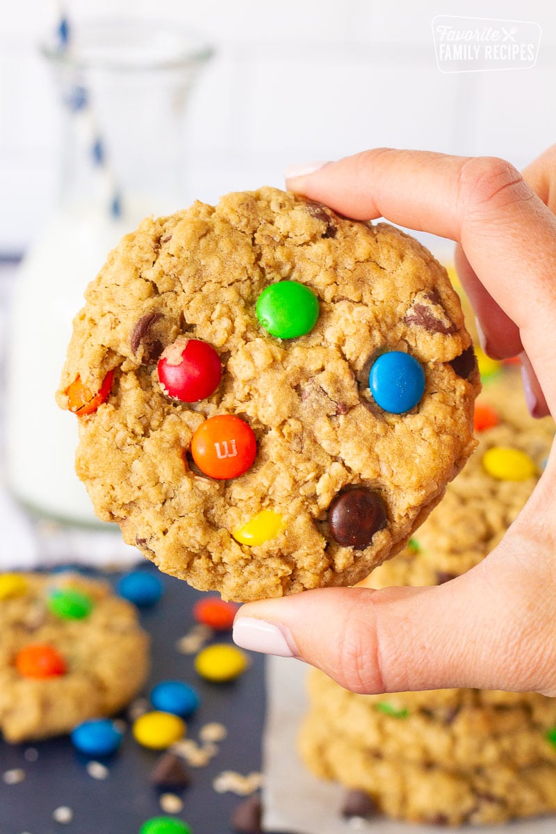 Hand holding a single Monster Cookie.