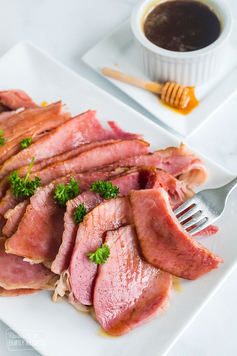 A plate of honey baked ham cut into slices