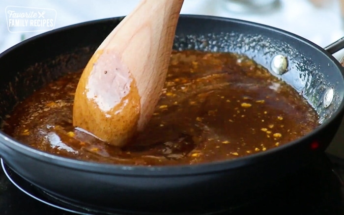 A saucepan with honey baked ham glaze being cooked