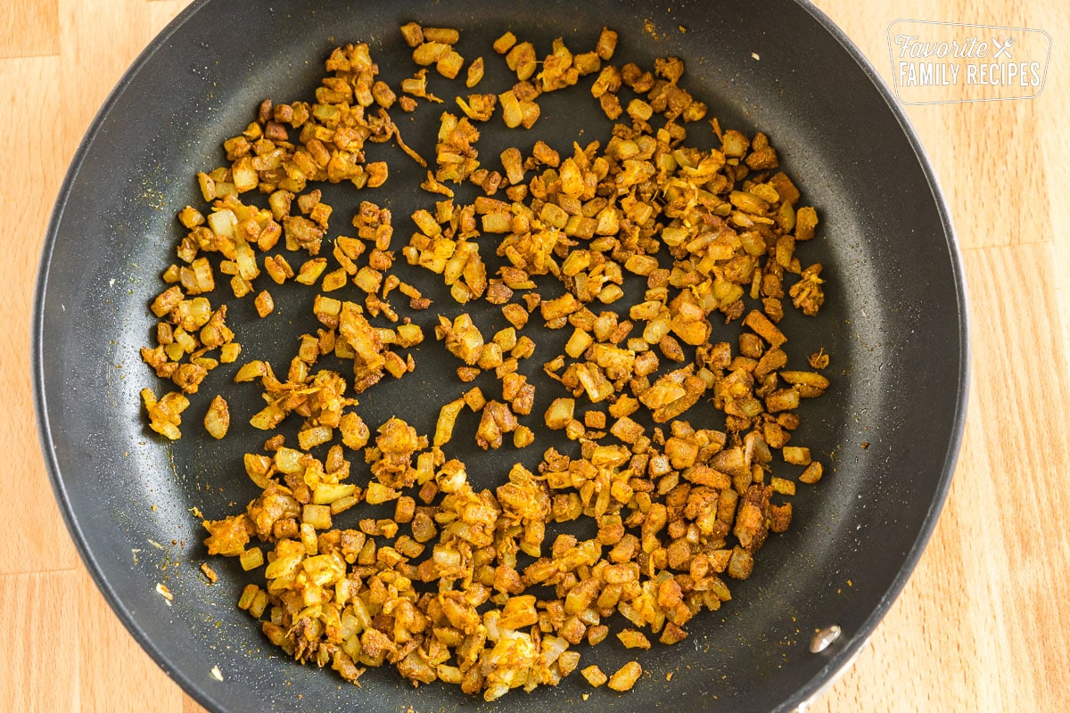 Onions, garlic, and ginger sauteed in a pan with spices