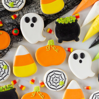 Decorated Halloween Cookies in the shapes of ghosts, pumpkins, candy corns, cauldrons and spider webs.
