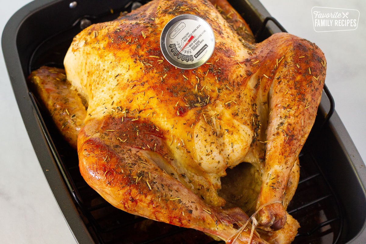 Meat thermometer in a cooked turkey for Turkey covered with foil for How to Cook a Turkey.
