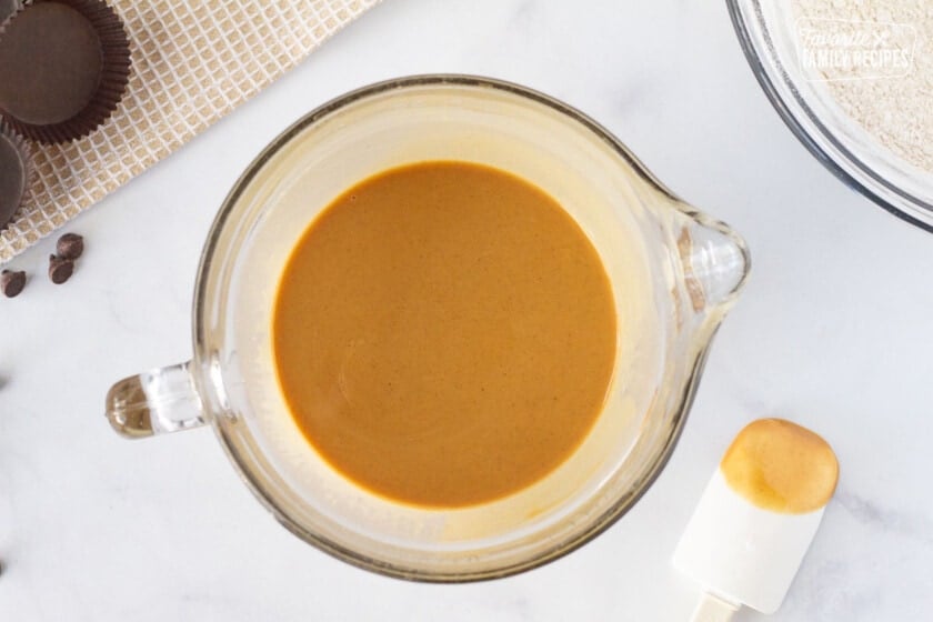 Bowl of melted peanut butter and butter mixture to make the filling for Homemade Reese's Peanut Butter Cups.