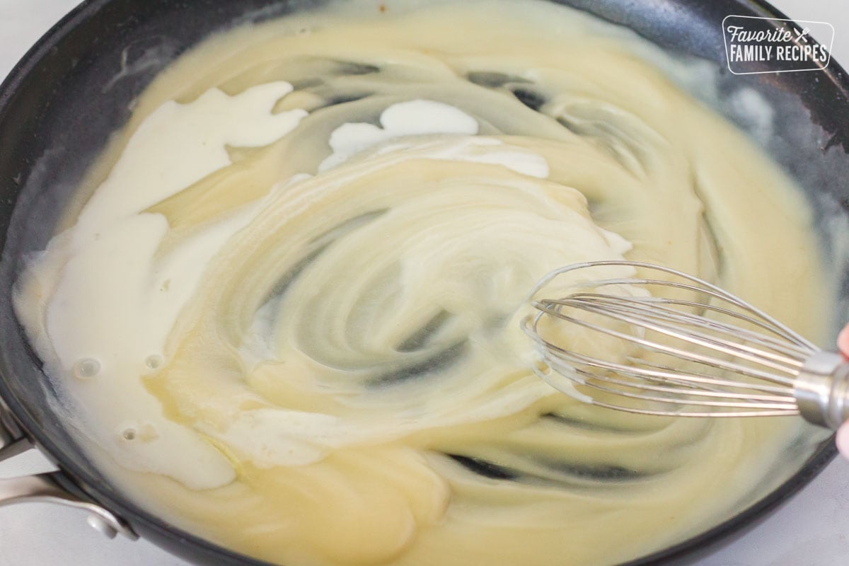 Pan with whisk mixing Green Bean Casserole sauce.