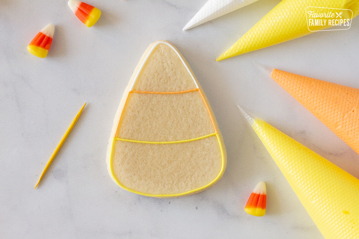 Candy Corn Halloween cookie outlined with royal icing.
