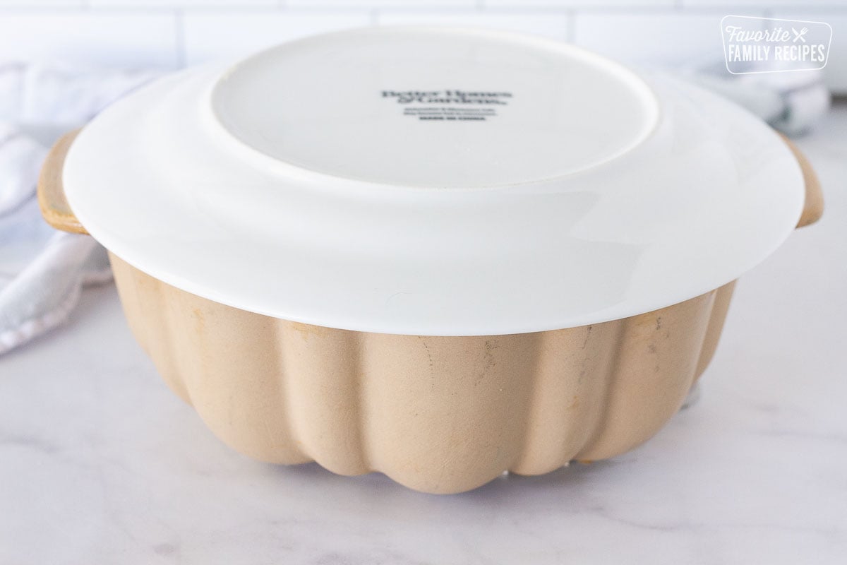 Plate on top of a bundt pan for flipping Easy Monkey Bread.