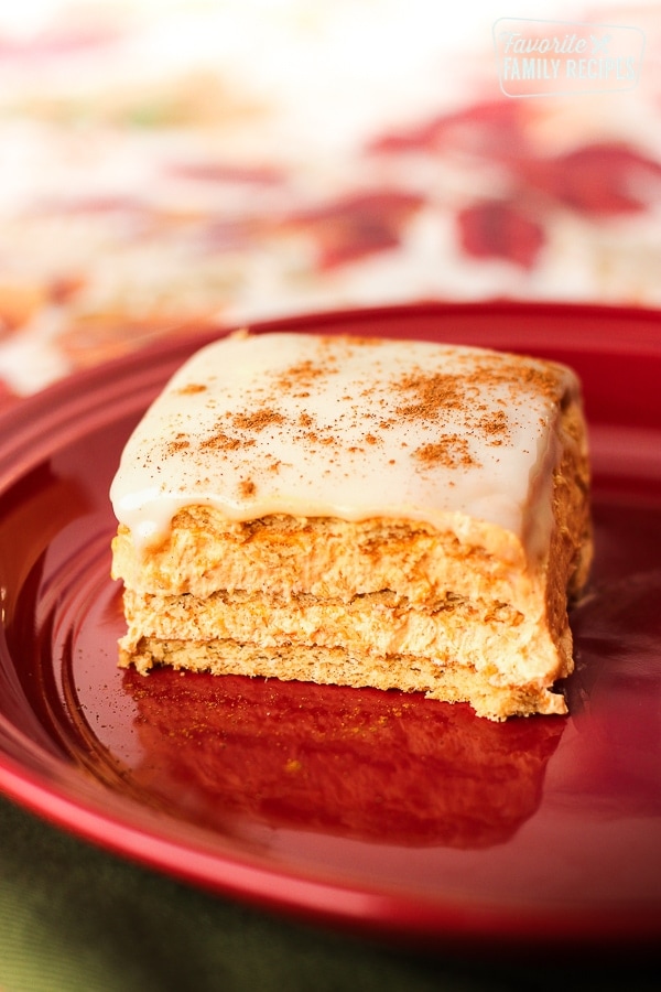Pumpkin eclair cake on a red plate.