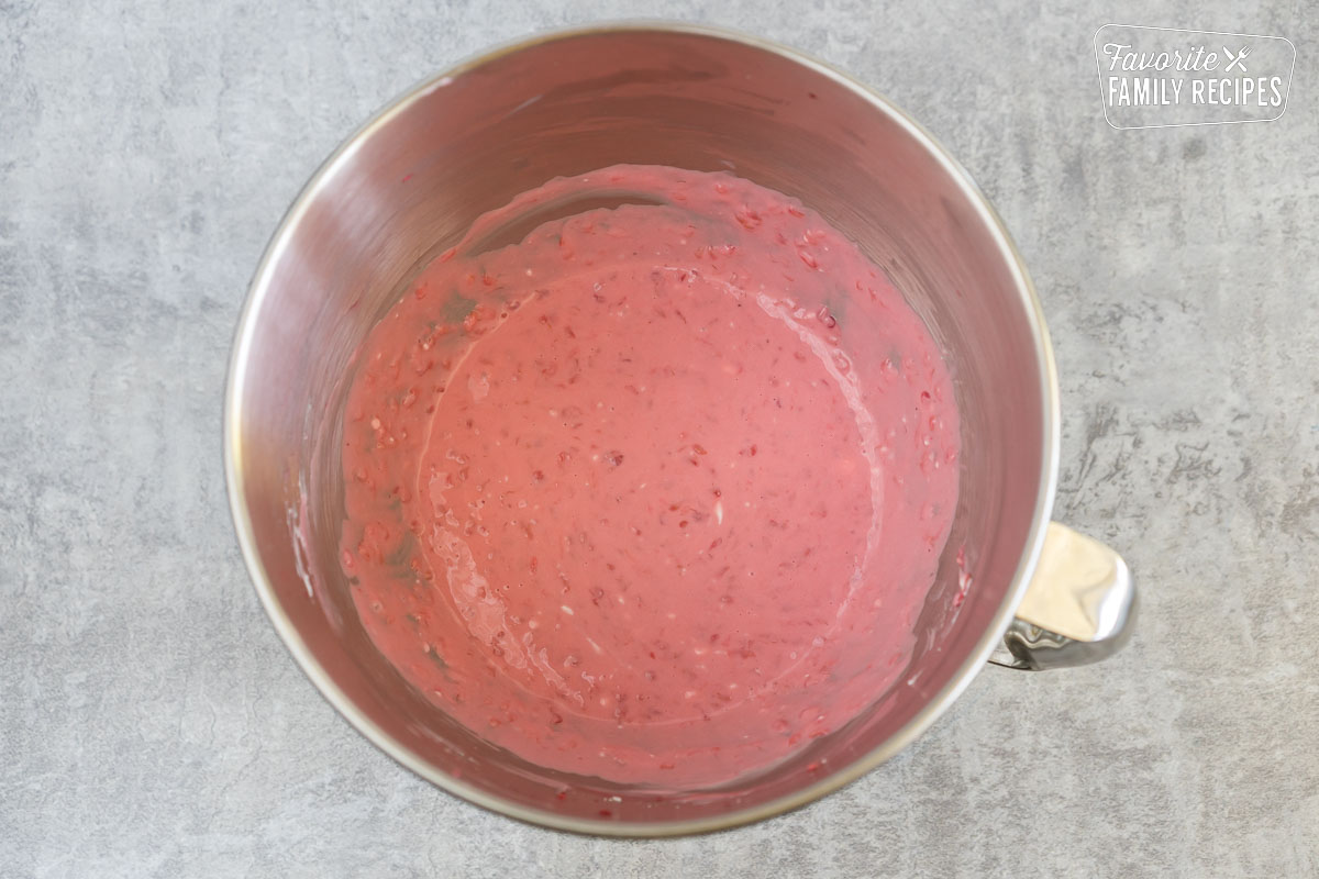 Raspberry cream cheese mixture in a mixing bowl
