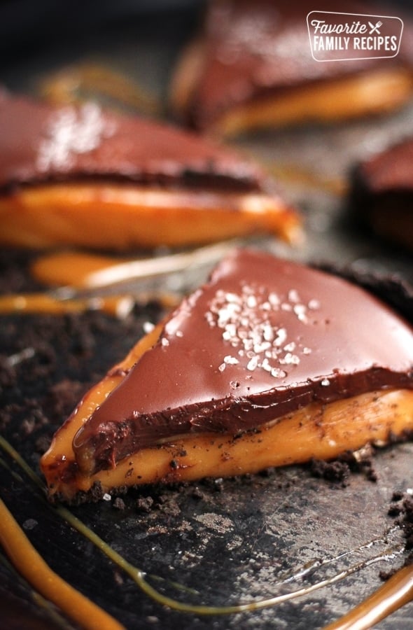 Salted caramel pie on a black plate.