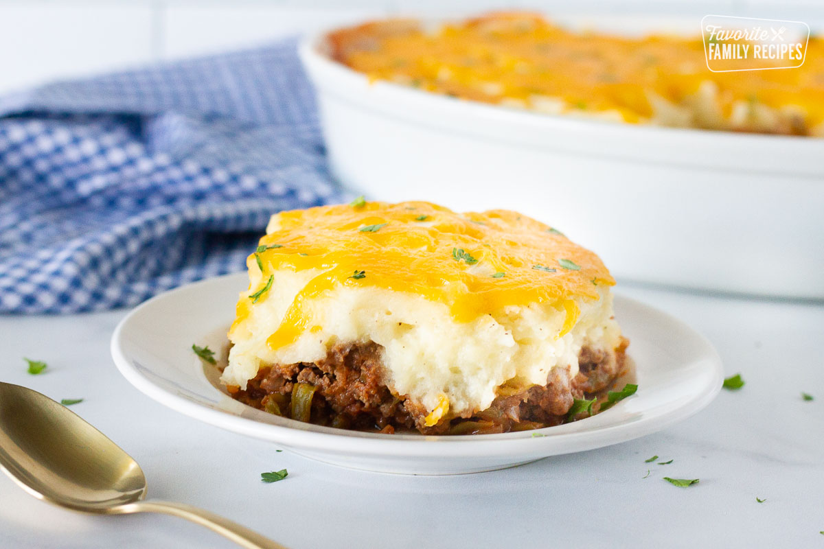 Serving of Easy Shepherd's Pie on a plate. Baking dish in the background.