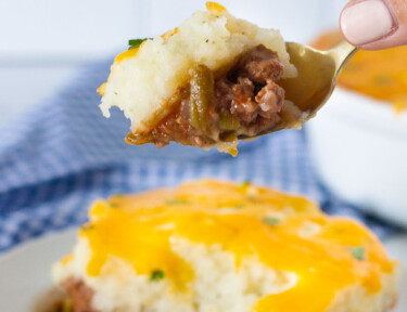 Hand holding a spoon with Easy Shepherd's Pie.