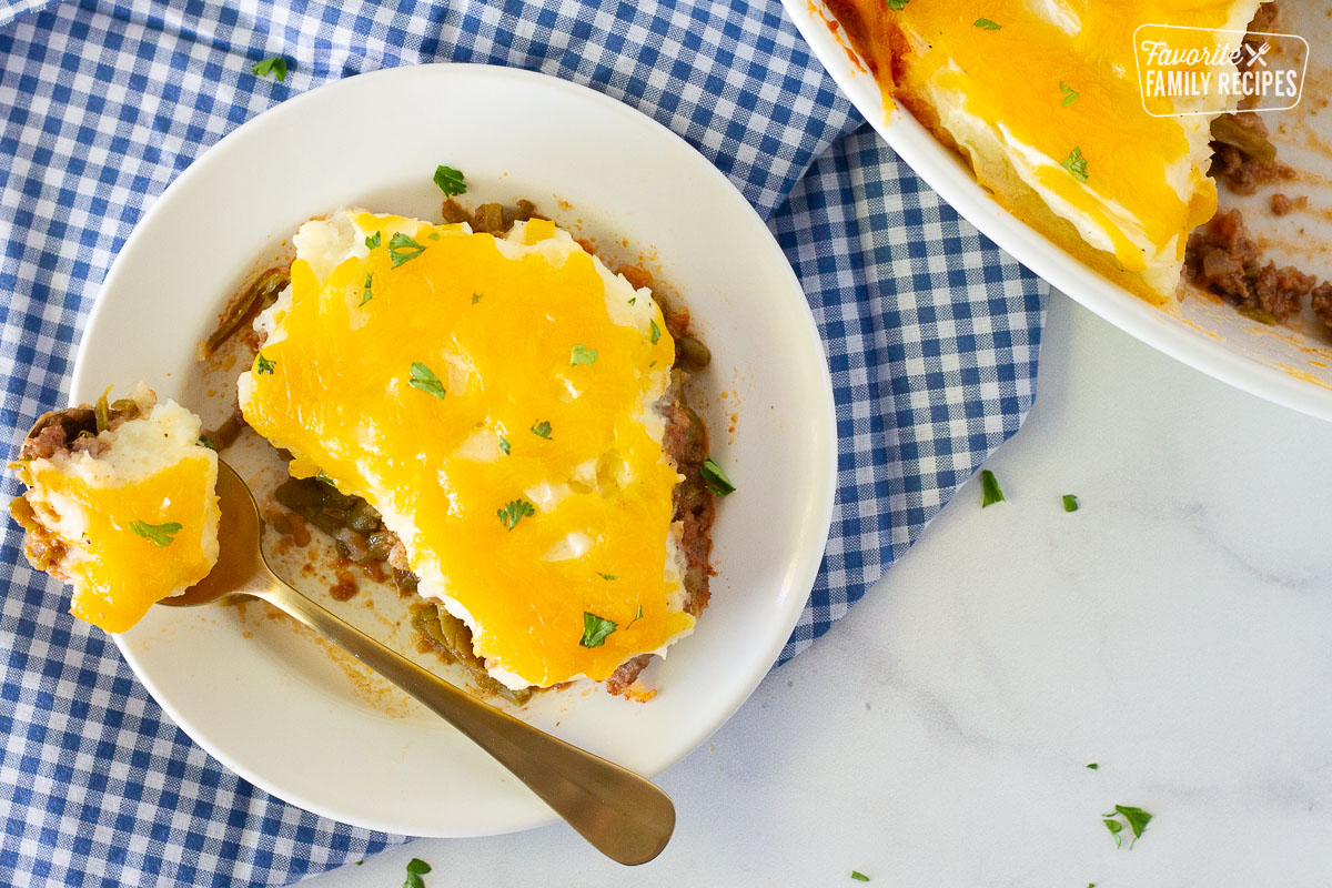 Spoon with Easy Shepherd's Pie resting on a plate.