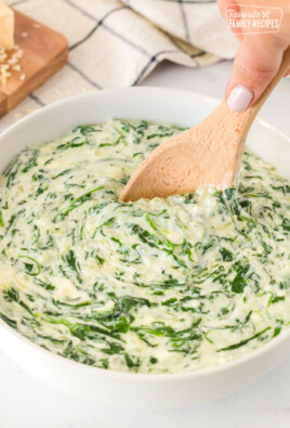Spoon scooping into a bowl of Creamed Spinach.