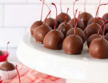 Stand of Chocolate Covered Cherries with more Chocolate Covered Cherries under the stand.