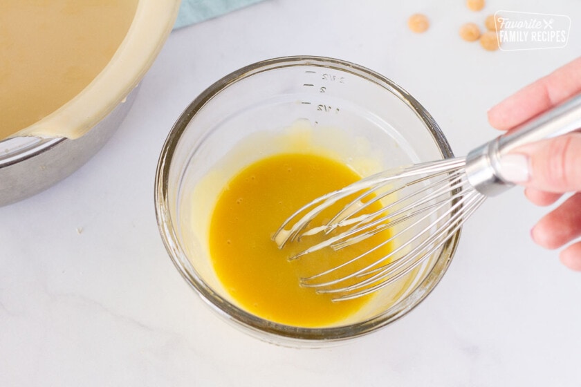Tempering yolks in a bowl with a whisk for Butterscotch Pie filling.