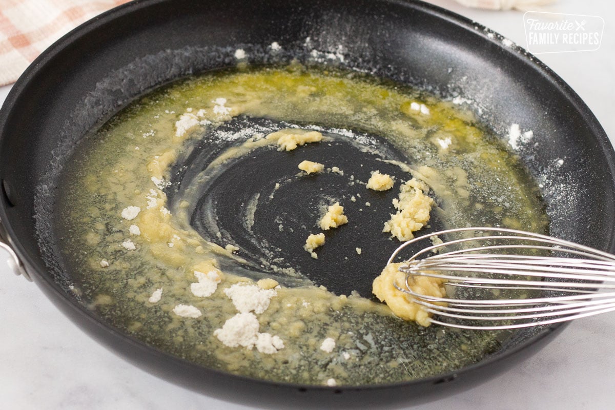 Whisking melted butter and flour in a skillet for Easy Turkey Pot Pie.