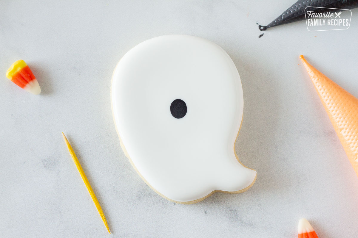 Ghost Halloween Cookie with white icing and a black oval.