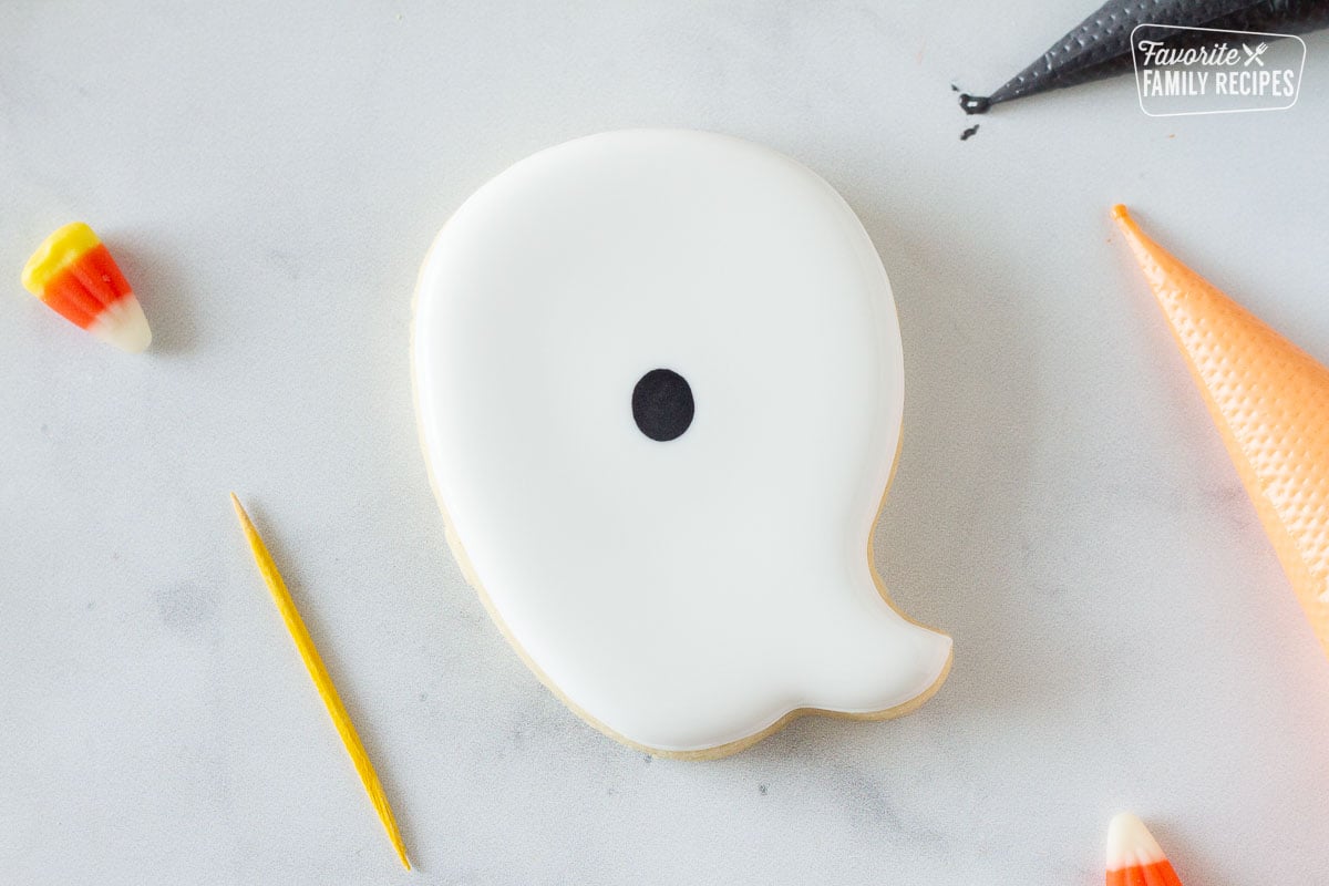 Ghost Halloween Cookie with white icing and a black oval.