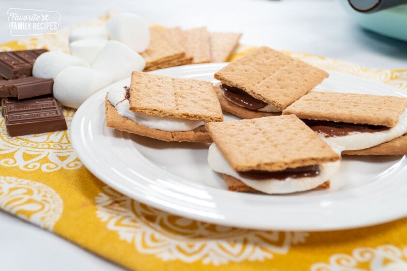 4 Smore's on a plate with an air fryer in the background