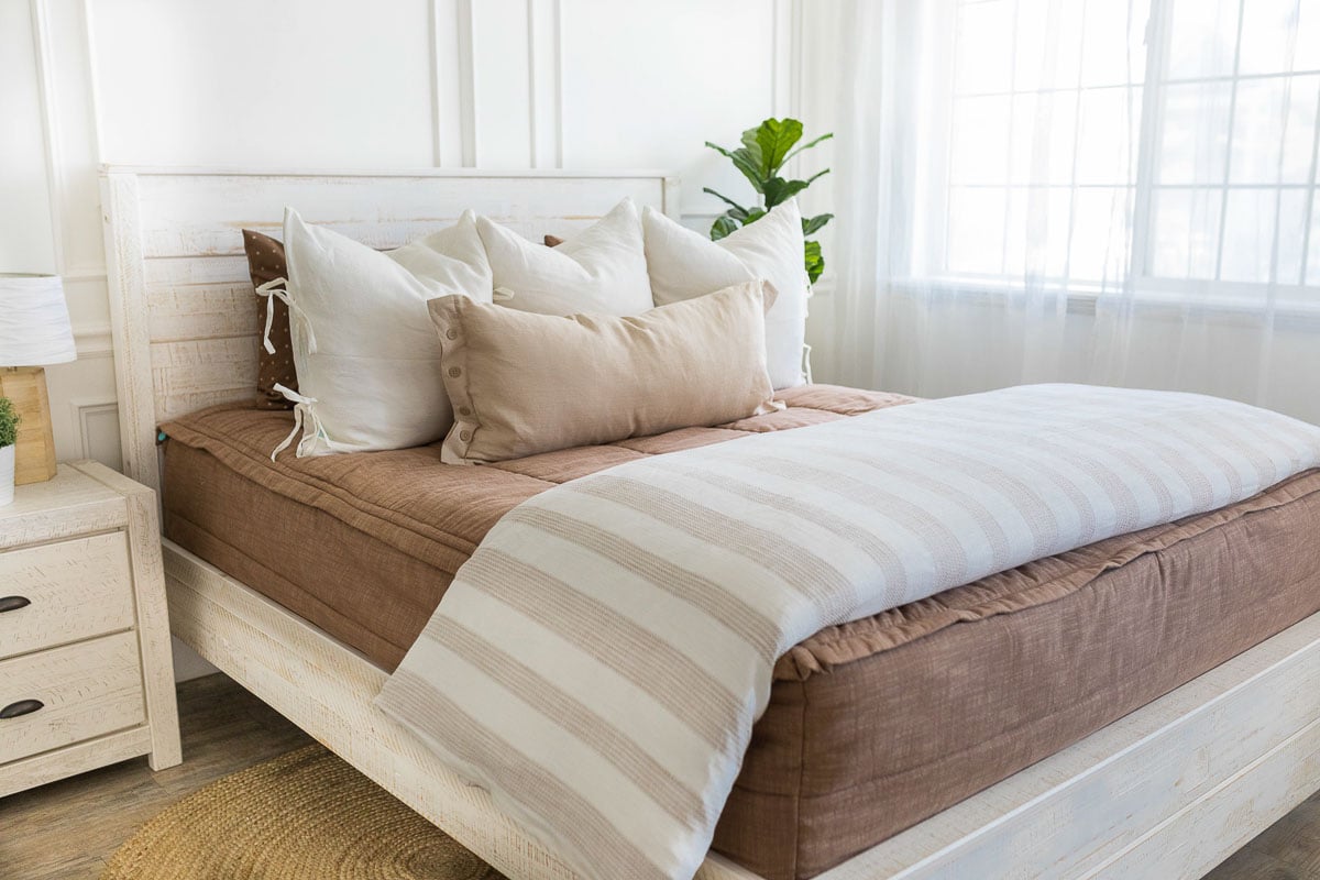 Brown zipper bedding on a queen sized bed