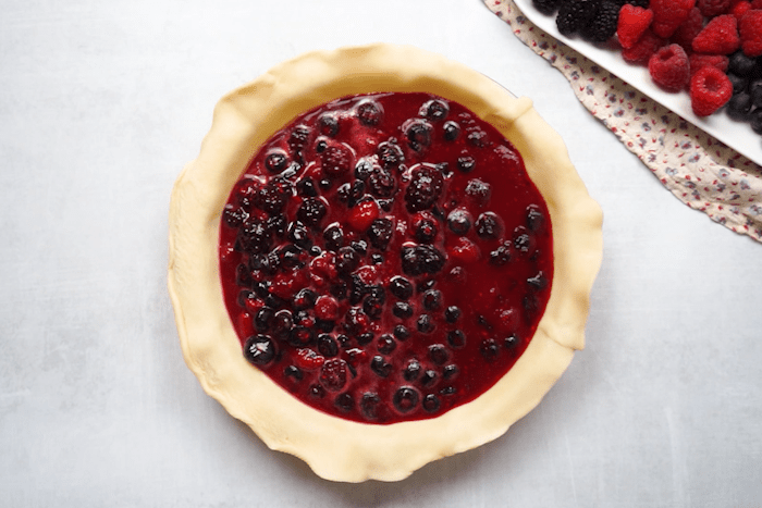 Berry mixture poured into pie crust for Easy Berry Pie.