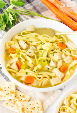 Spoon resting in bowl of Homemade Chicken Noodle Soup.