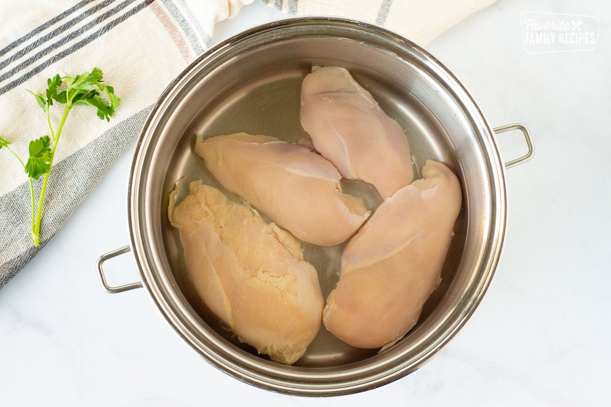 Chicken in a pot of water for Homemade Chicken Noodle Soup.