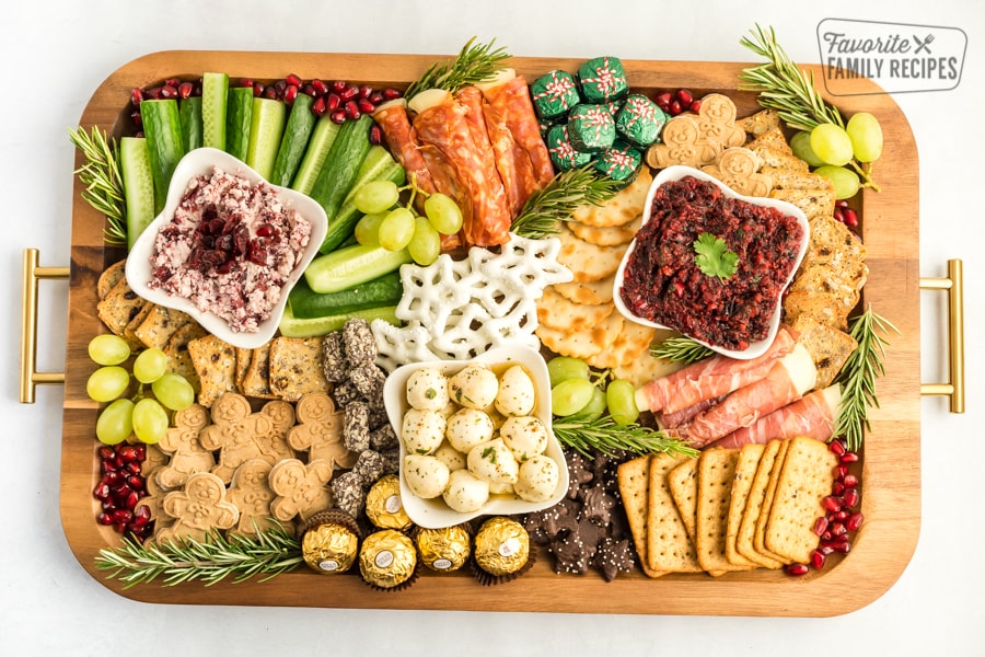 A Christmas Charcuterie Board on a wooden tray.