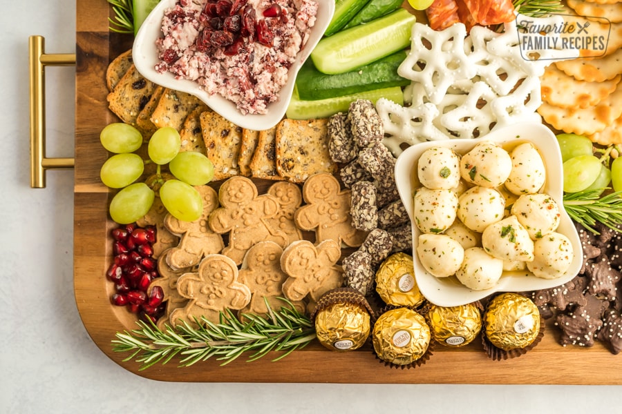 A Christmas Charcuterie Board on a wooden tray.