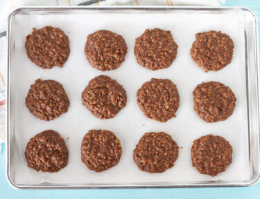 Cooled Easy No Bake Cookies on a cookie sheet.