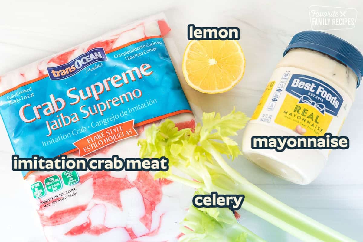 A package of imitation crab, celery, and a jar of mayonnaise.