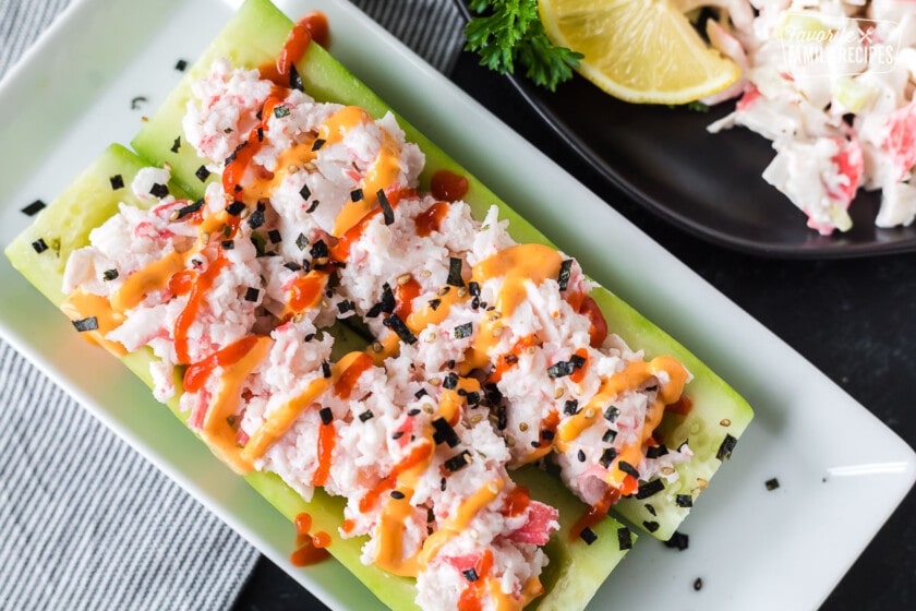 Cucumber boats stuffed with crab salad and topped with sriracha.