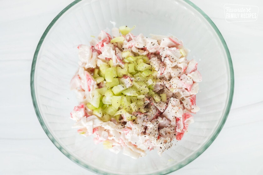 Imitation crab in a bowl with mayonnaise and celery.