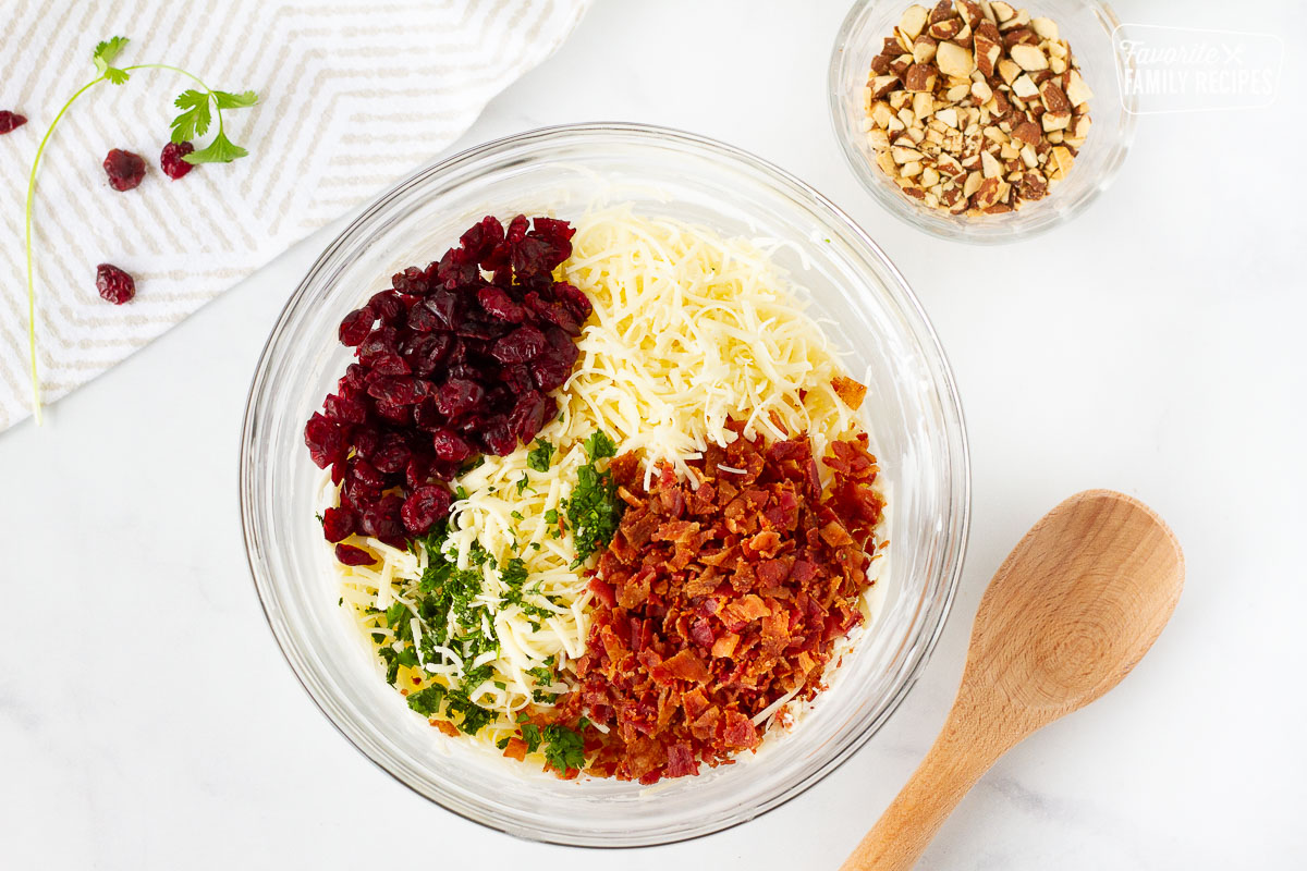 Bowl of bacon, raisins, cilantro, white cheddar and cream cheese to make a Cranberry Almond Bacon Cheese Ball.