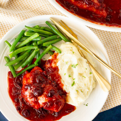 Plate of Cranberry Chicken, green beans and mashed potatoes.