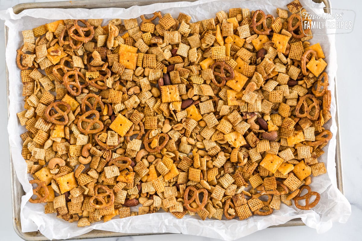 Chex Mix cooling on a baking sheet.