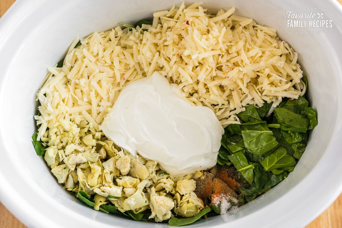 Spinach artichoke dip ingredients in a crockpot