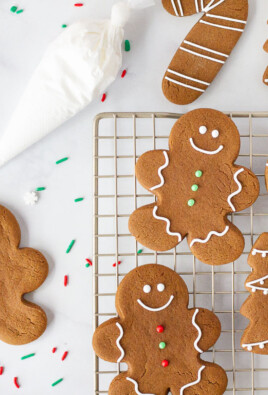 Gingerbread Cookies on a cooling rack next to an undecorated Gingerbread Man.