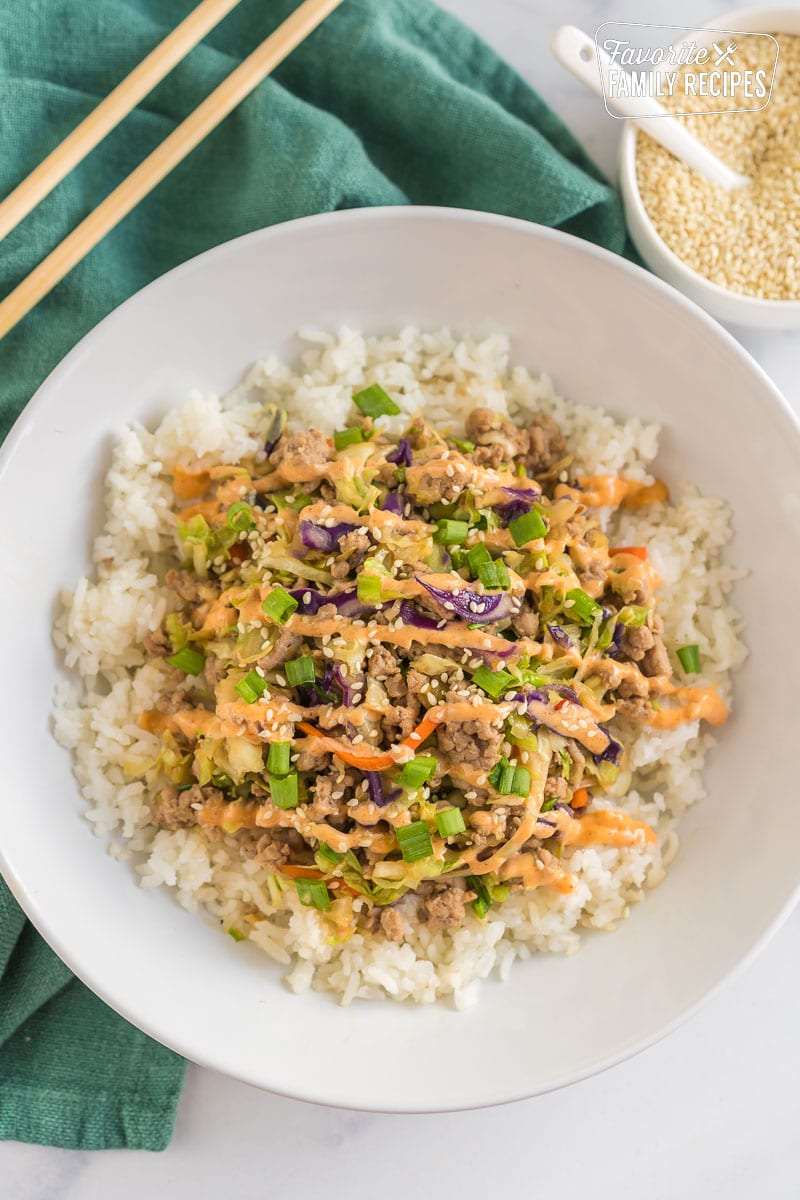Egg Roll Bowl topped with spicy mayo and sesame seeds