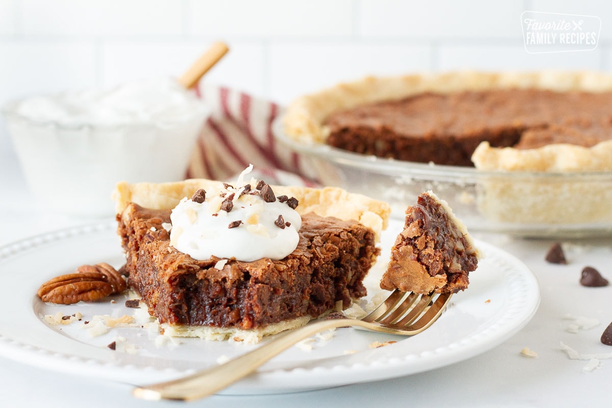 Plate of German Chocolate Pie next to a fork holding a bite of pie.