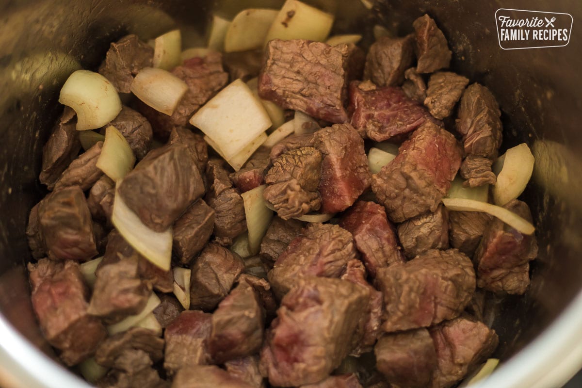 Beef and onions in an Instant Pot for Hungarian goulash