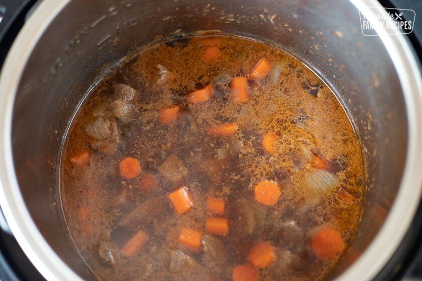 Broth, carrots, beef, and onion in an Instant Pot