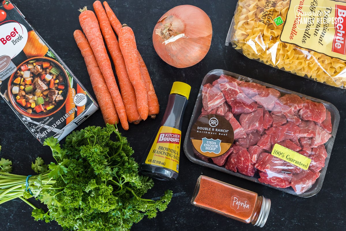Ingredients to make Instant Pot Goulash including stew meat, noodles, paprika, carrots, and onion