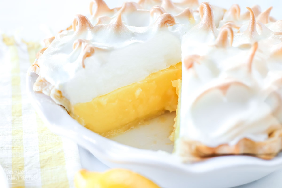 lemon meringue pie with a slice cut out of it