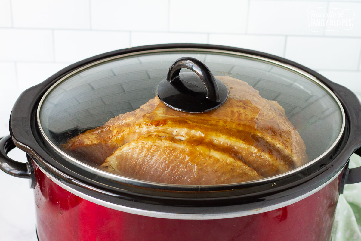 Lid covering a Crockpot with Spiral Ham inside.