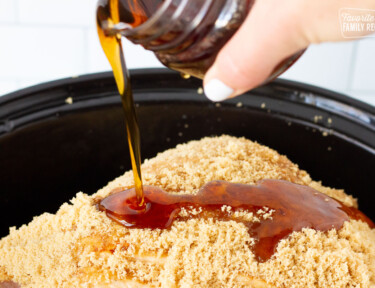Maple syrup pouring on a Spiral Ham in the Slow Cooker.